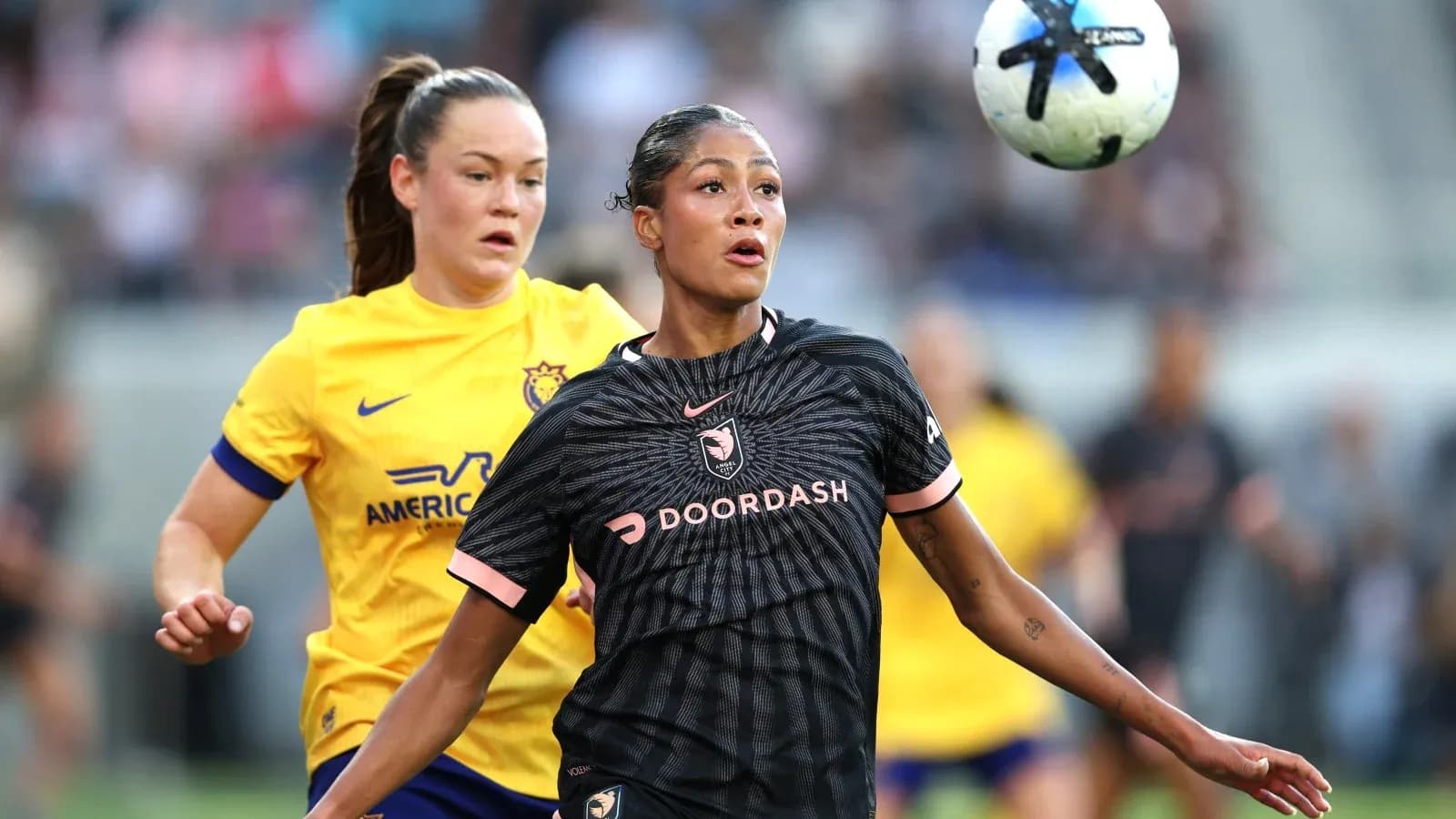 Angel City player challenging San Diego Wave opponent