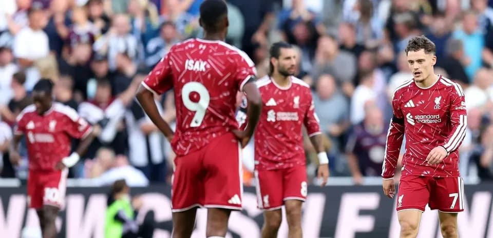 Liverpool players walking off the pitch after match