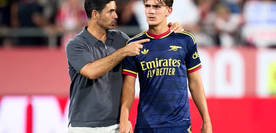 Coach talking to player on the field