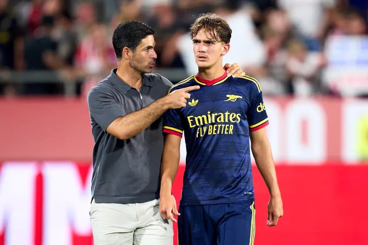 Coach talking to player on the field