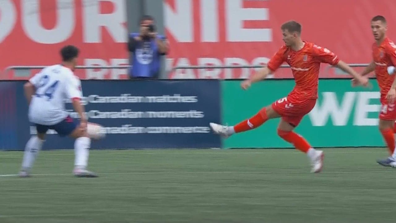 Player in red attempting to tackle opponent