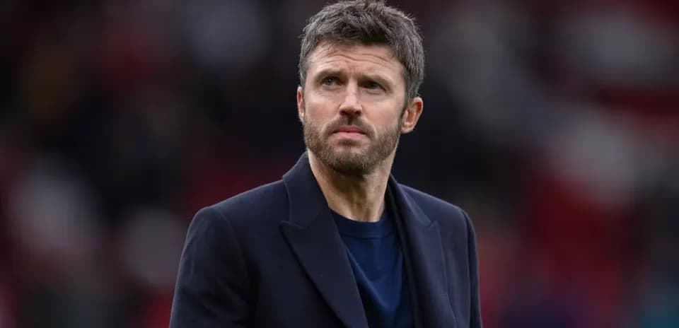 Man in a dark coat observing the pitch