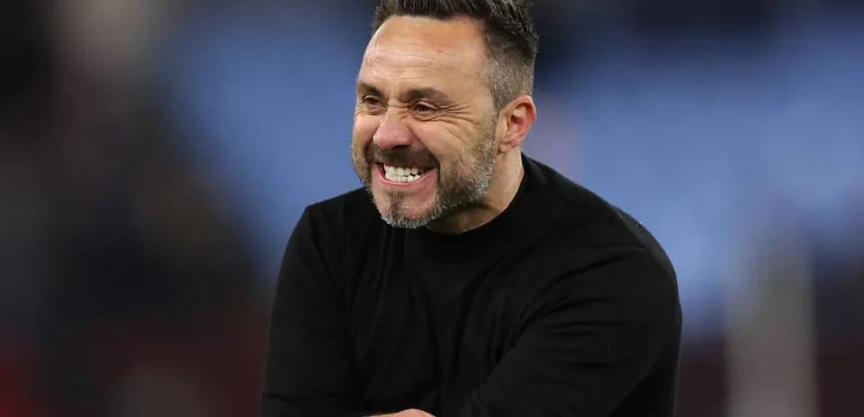 Coach celebrating with a smile on the field