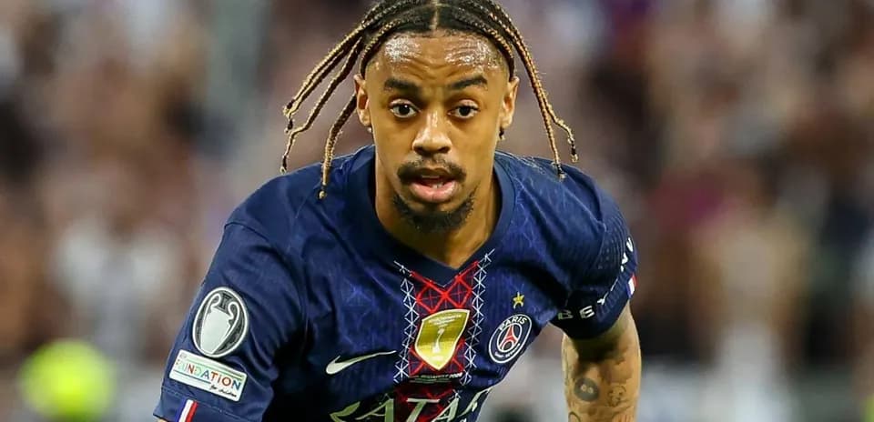 Player in PSG jersey running with the ball