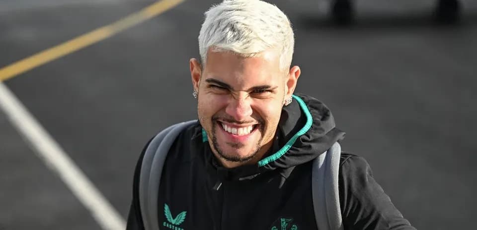Player smiling while wearing Newcastle United hoodie