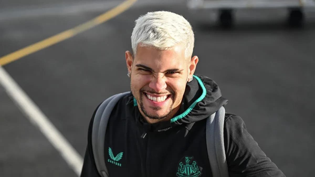 Player smiling while wearing Newcastle United hoodie