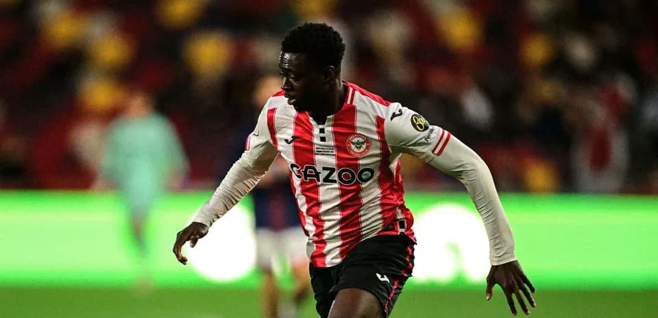 Brentford player sprinting on the pitch during match
