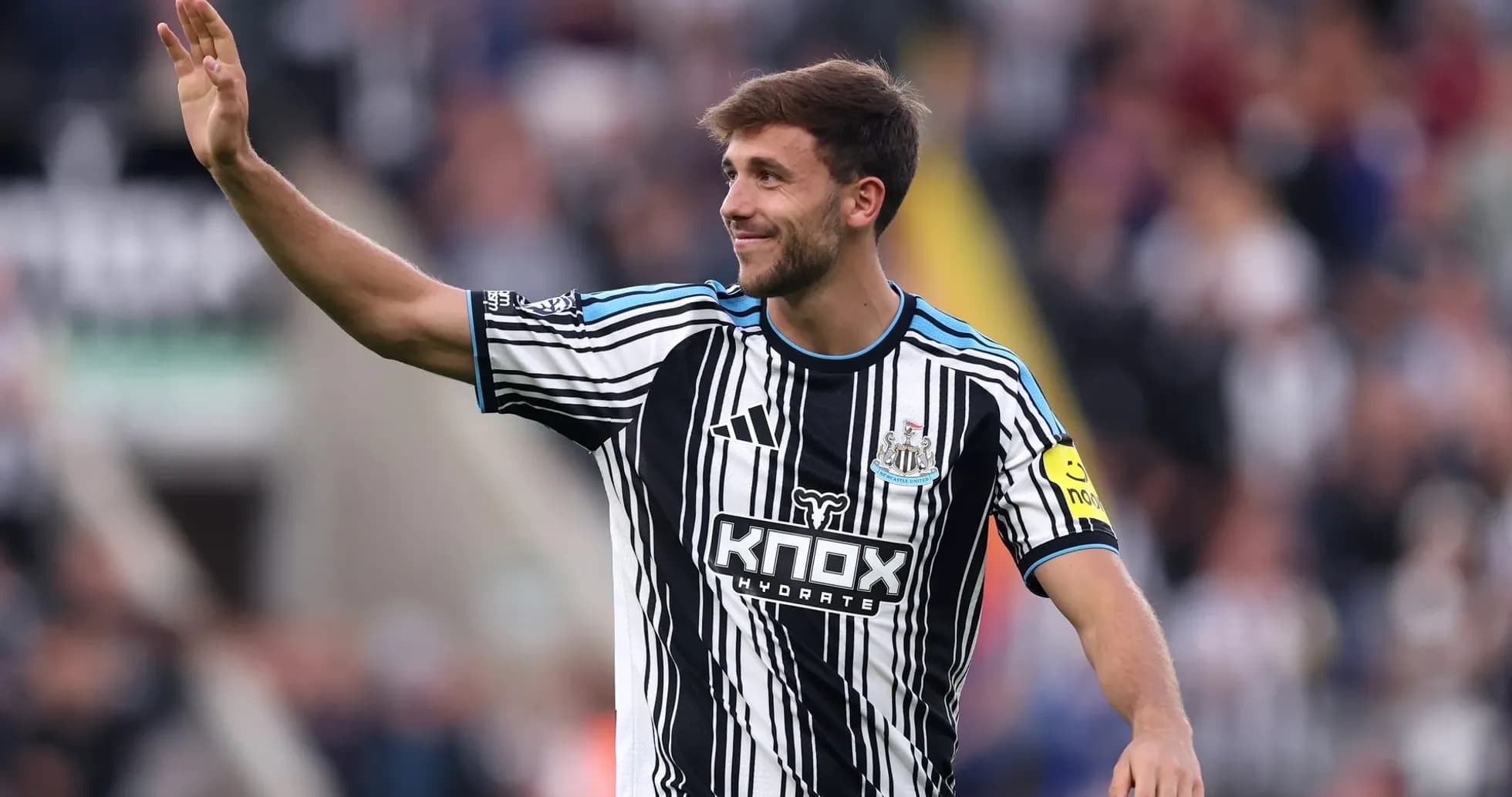 Newcastle player waving to the crowd during match