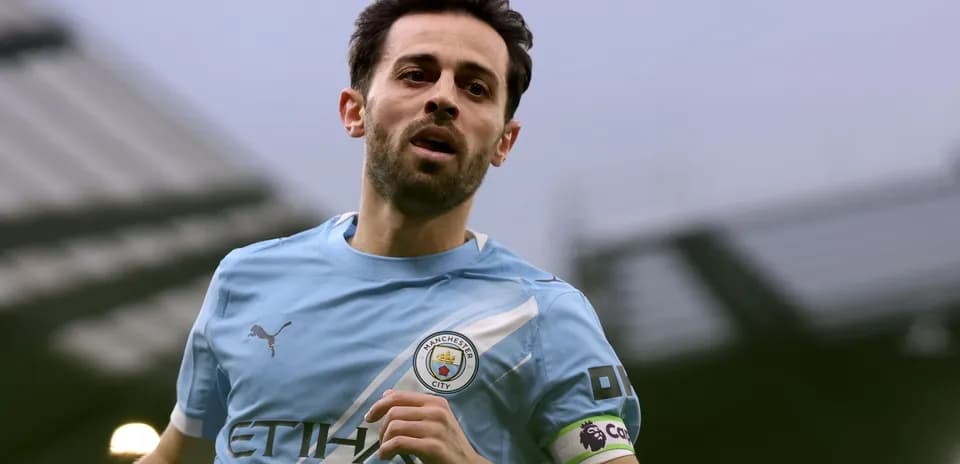 Player running in Manchester City home kit