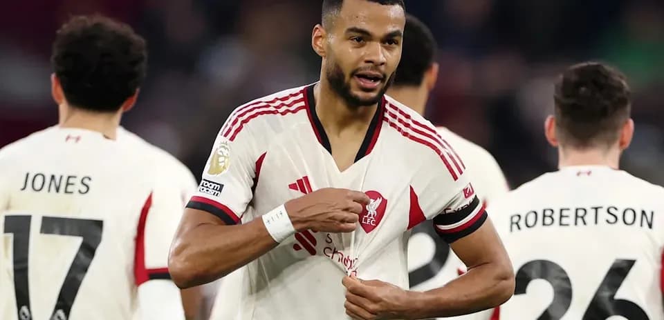 Liverpool player adjusting his shirt during match