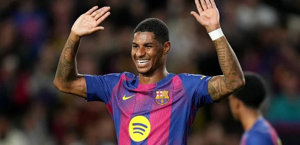 Player celebrating with raised hands on the pitch