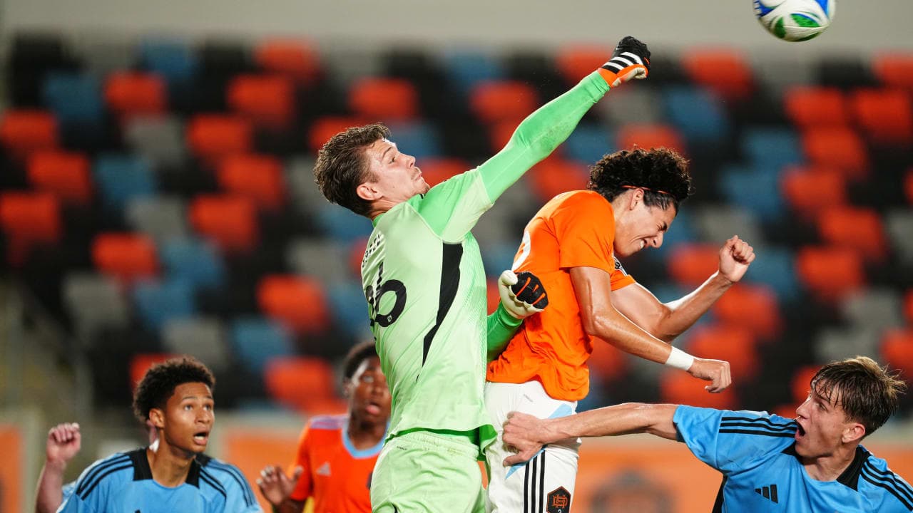 Goalkeeper punches the ball during match action