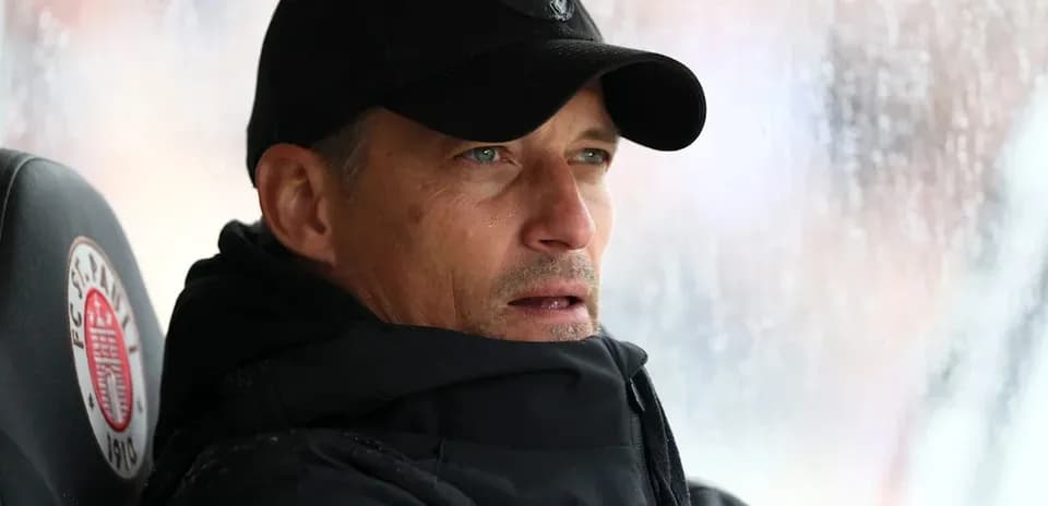 Coach observing from the bench during a match