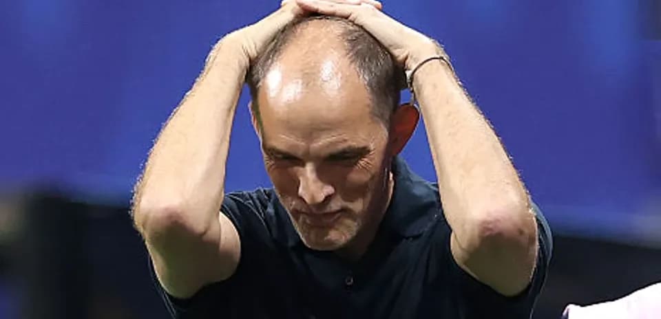 Coach holding head in frustration during match