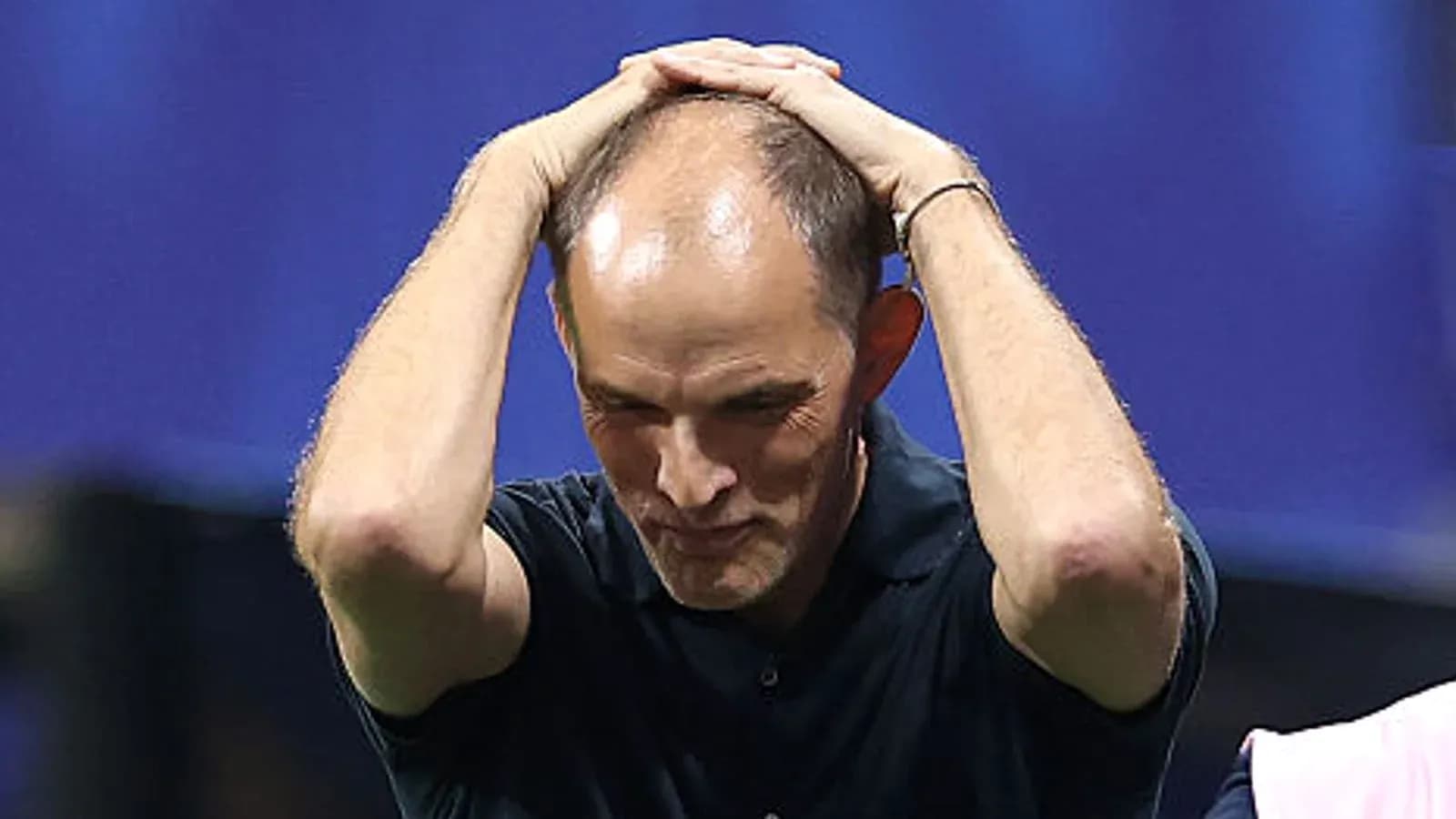 Coach holding head in frustration during match