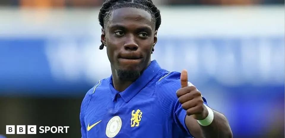 Player in blue jersey giving thumbs up gesture