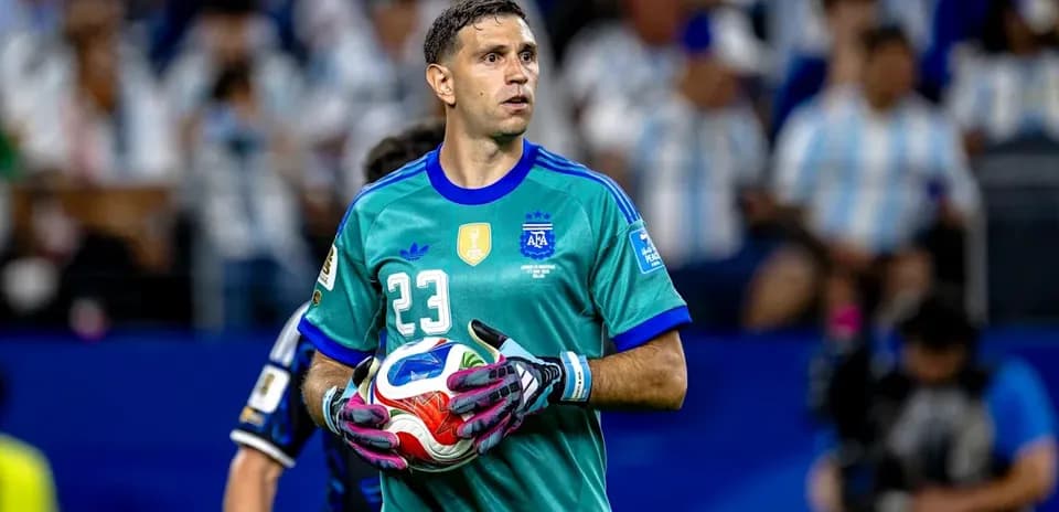 Goalkeeper holding ball during match at stadium