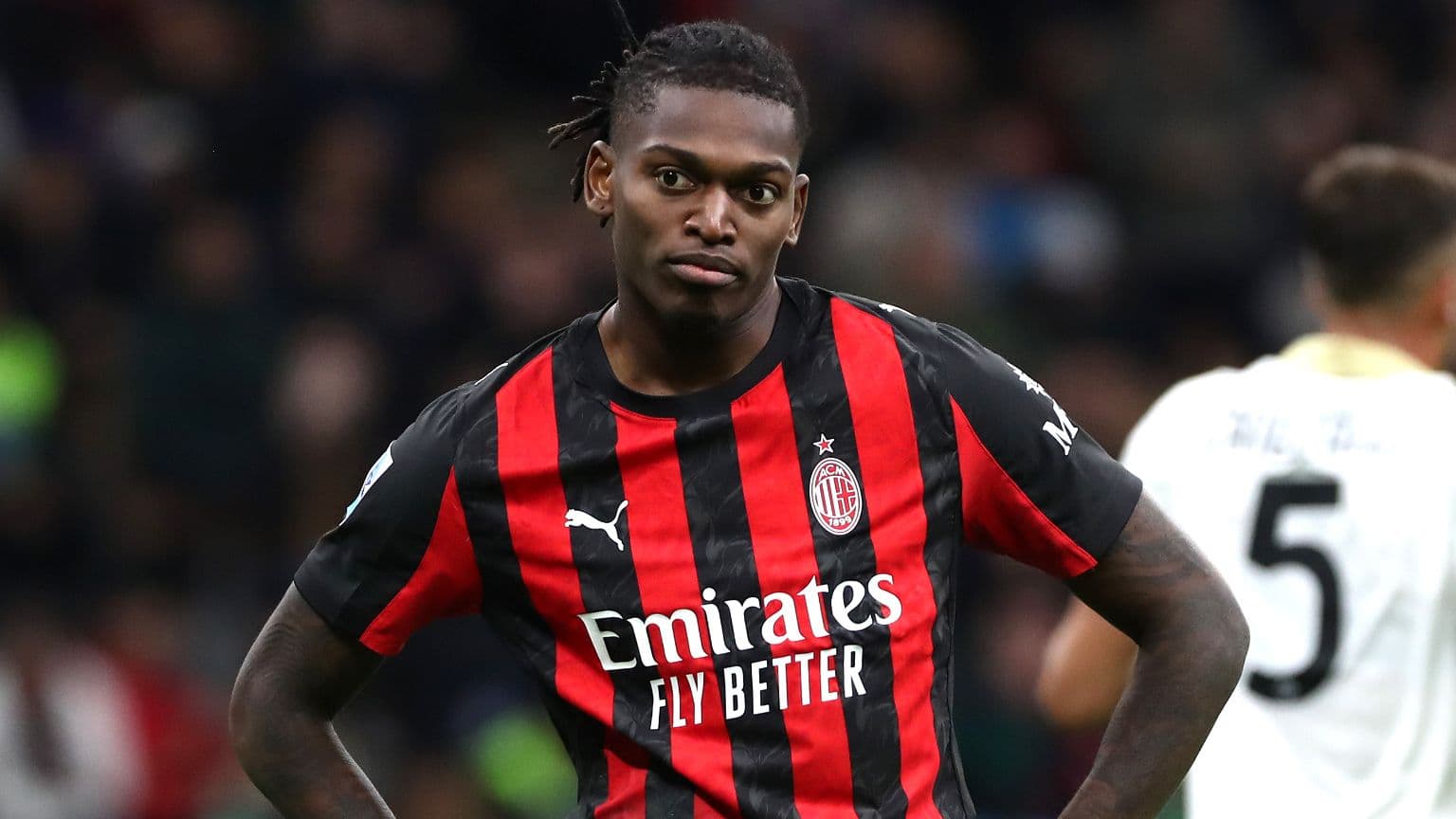 Player in AC Milan jersey on the field