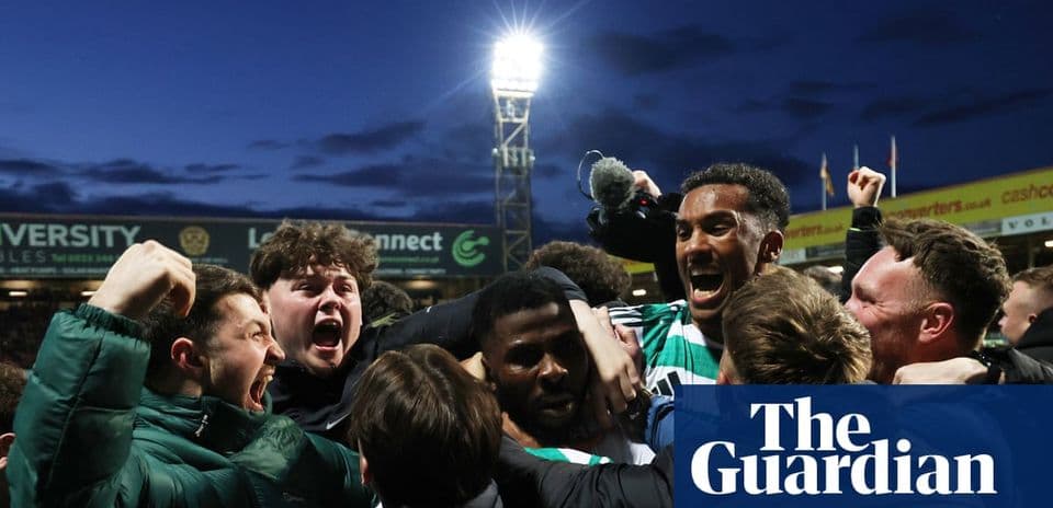 Fans celebrating a goal with players at stadium
