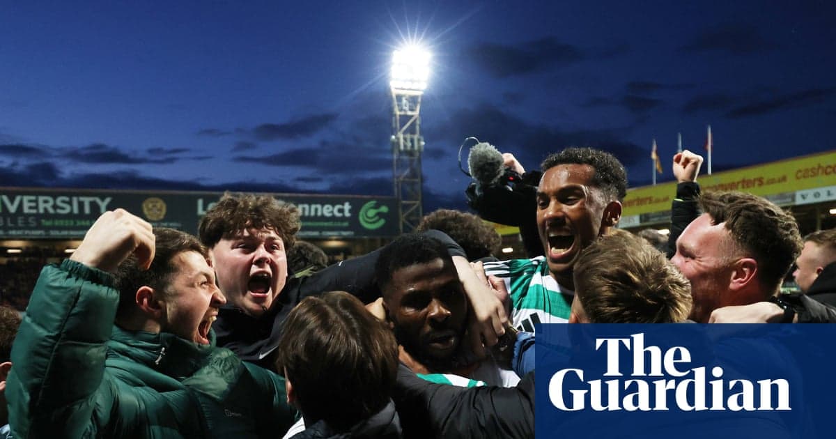 Fans celebrating a goal with players at stadium