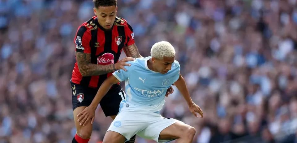 Player from Bournemouth challenges Manchester City player