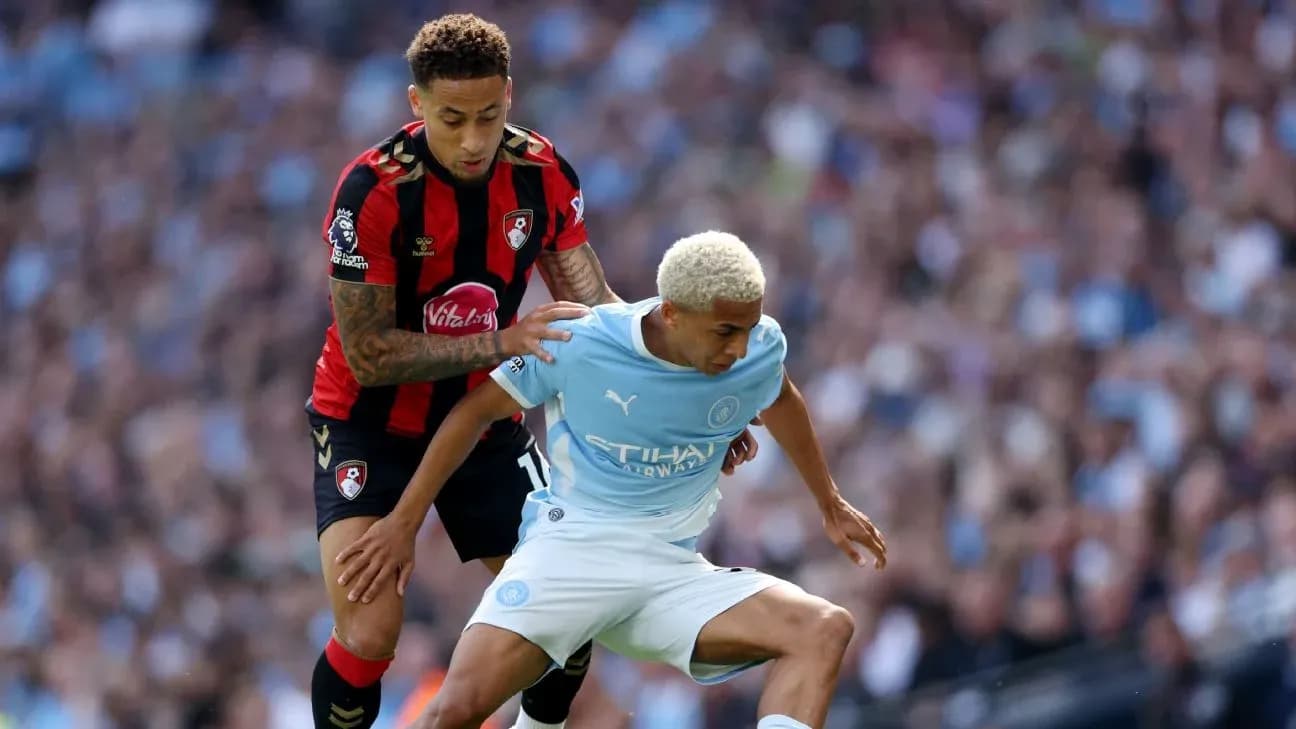 Player from Bournemouth challenges Manchester City player