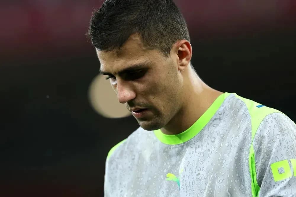 Goalkeeper in training gear looking down