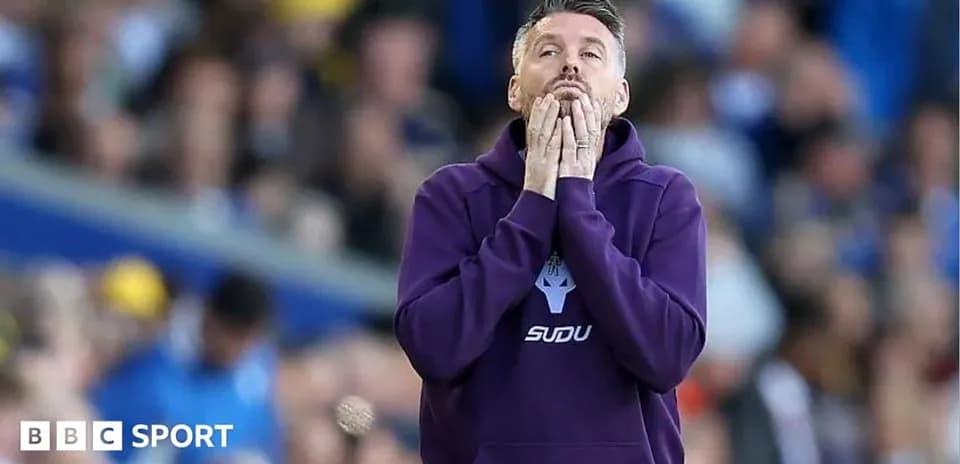 Coach showing concern during match on the sidelines