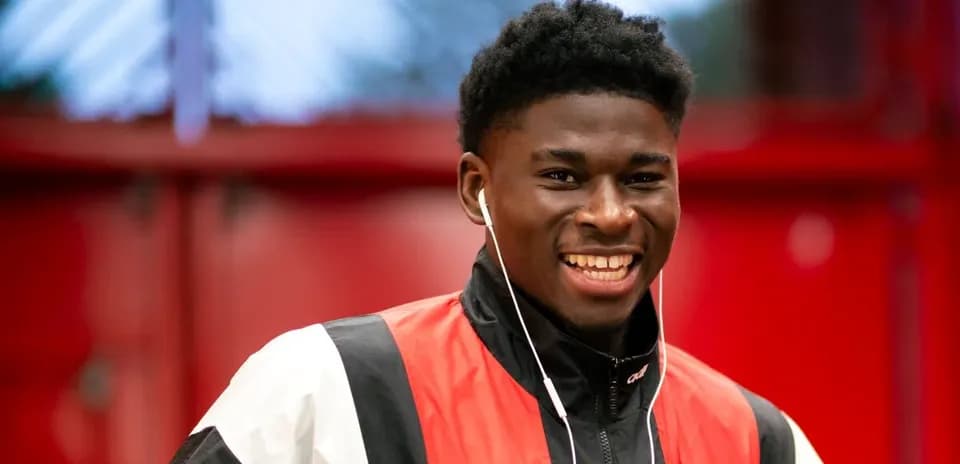 Player smiling while wearing headphones in training facility