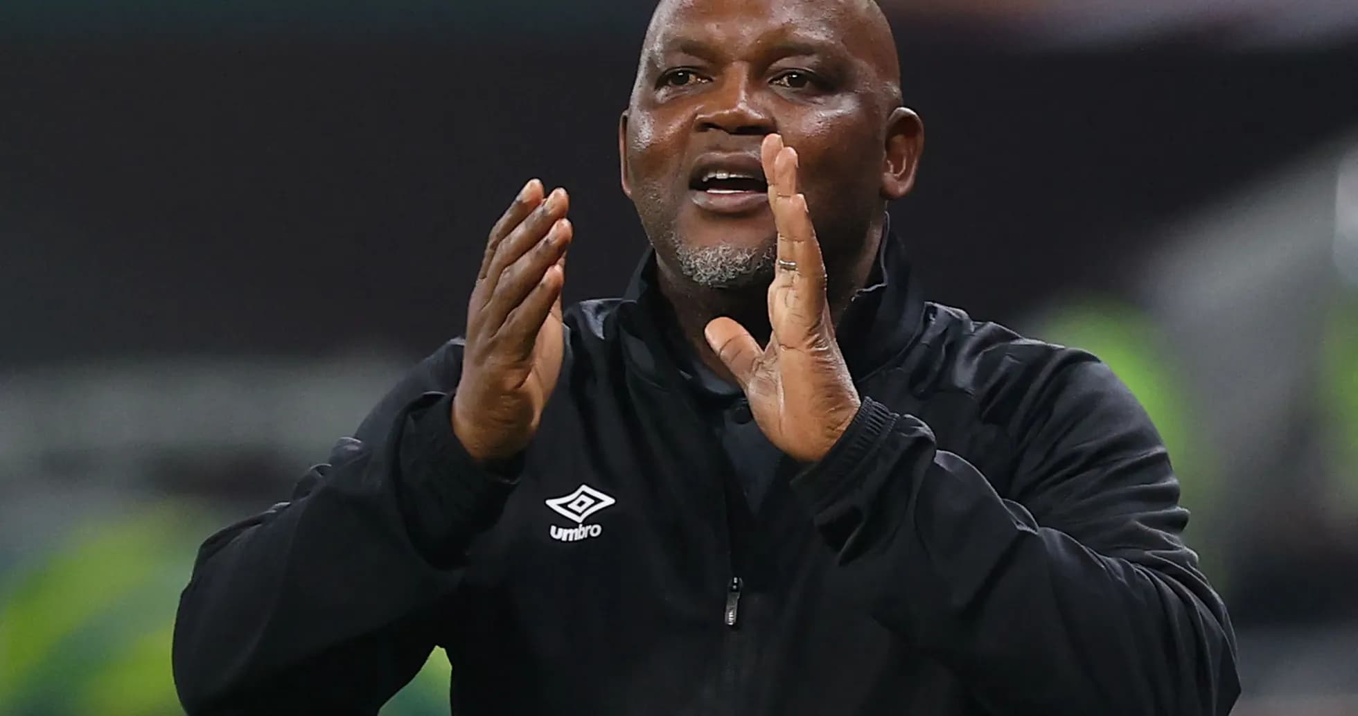 Coach gesturing during a match from the sidelines