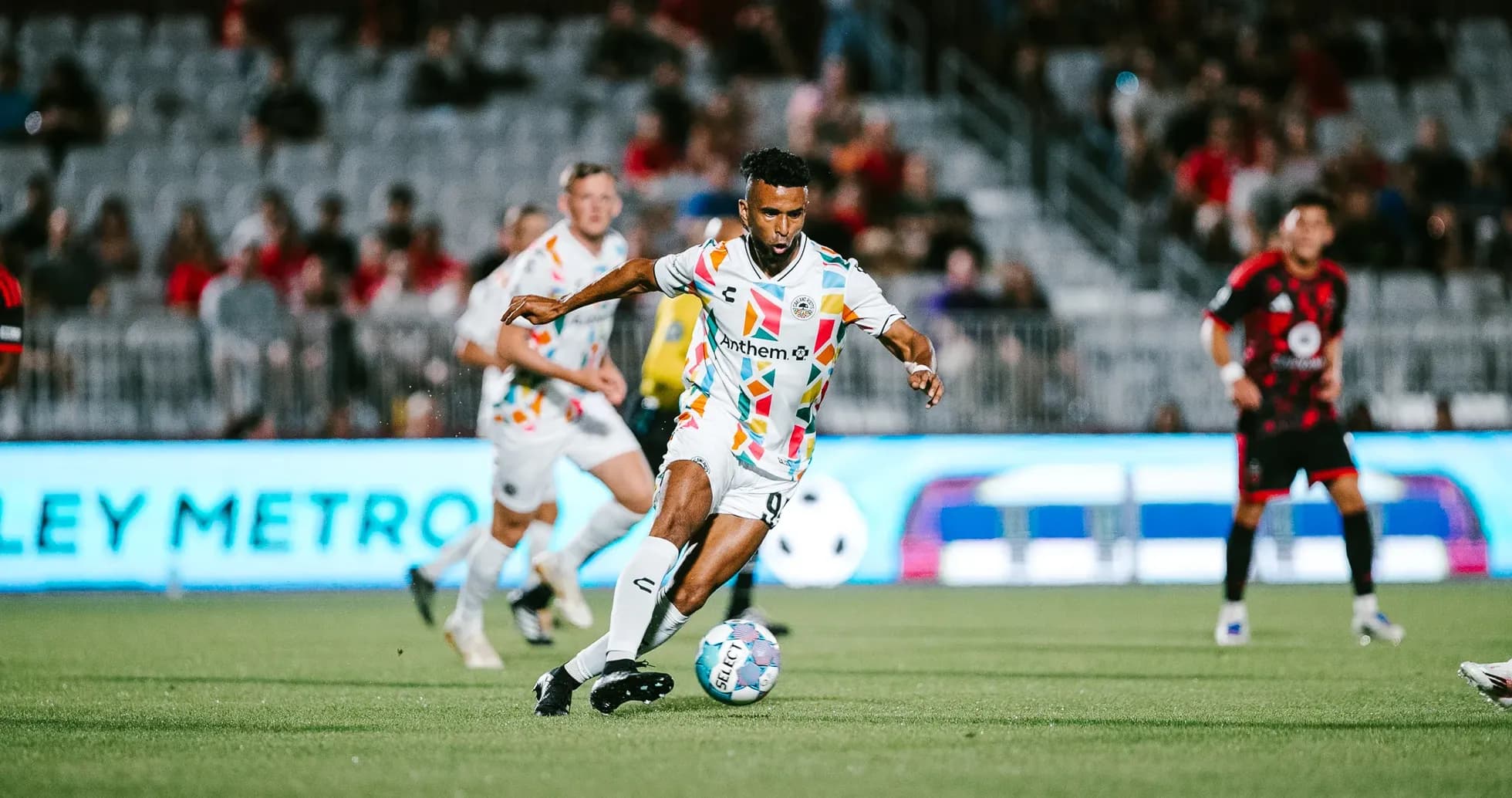 Player dribbling the ball during Phoenix Rising match