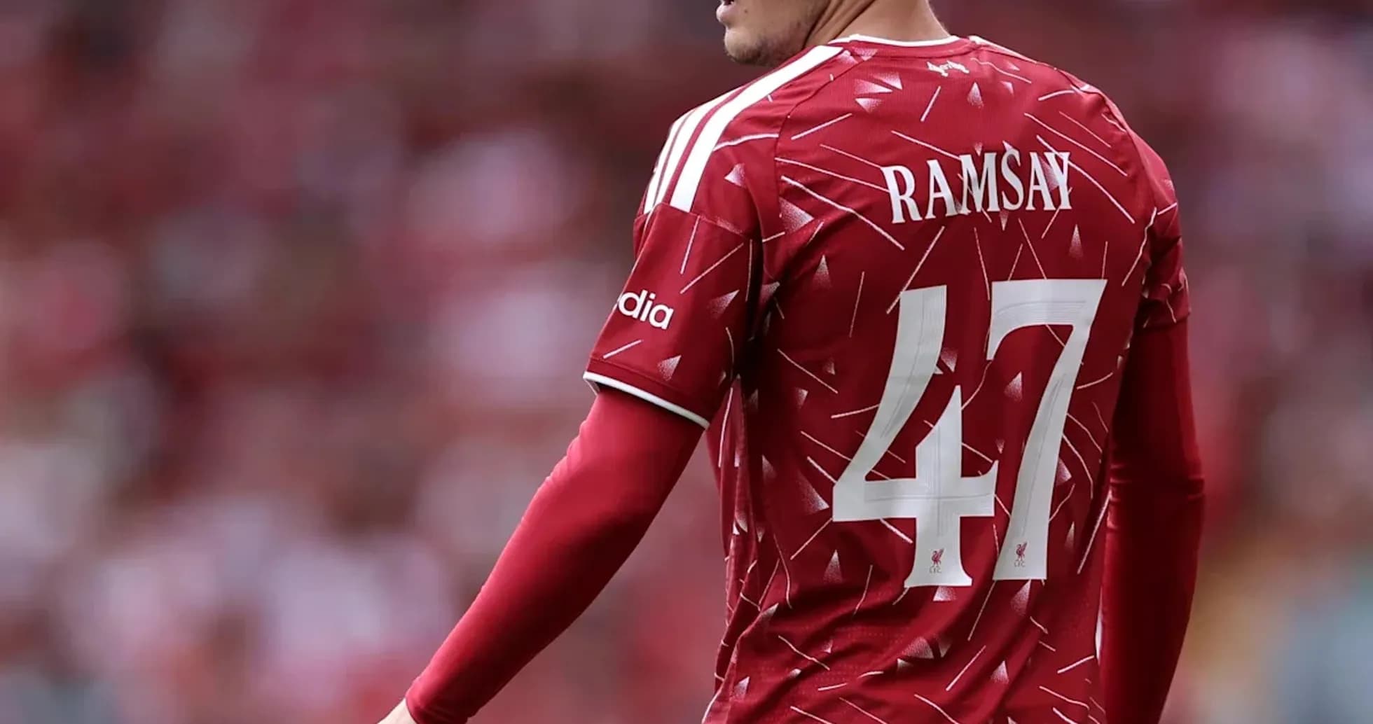 Player in red jersey during match at stadium