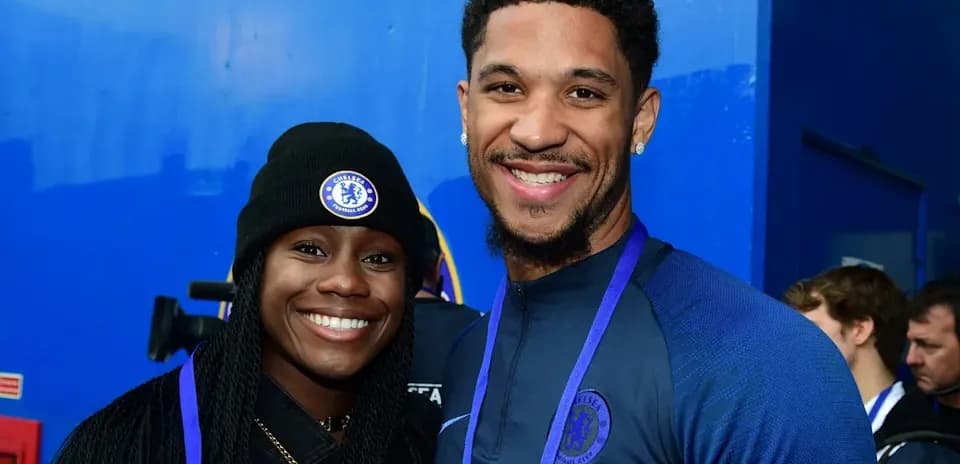 Two people posing together in Chelsea attire