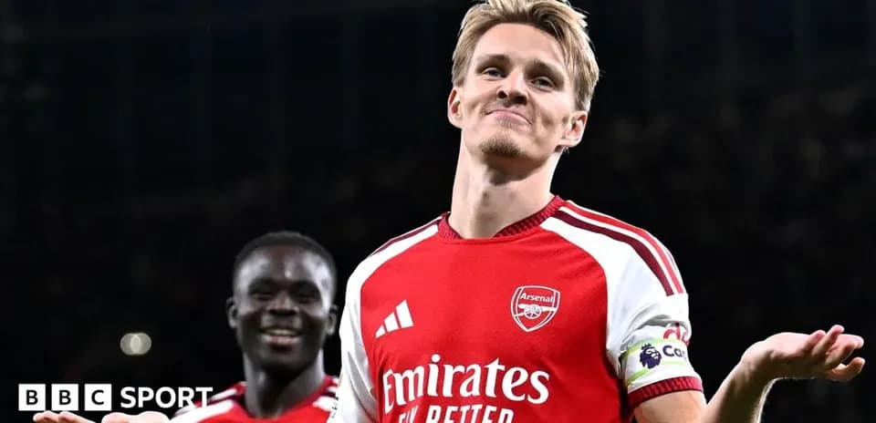 Arsenal player celebrating with teammates after scoring
