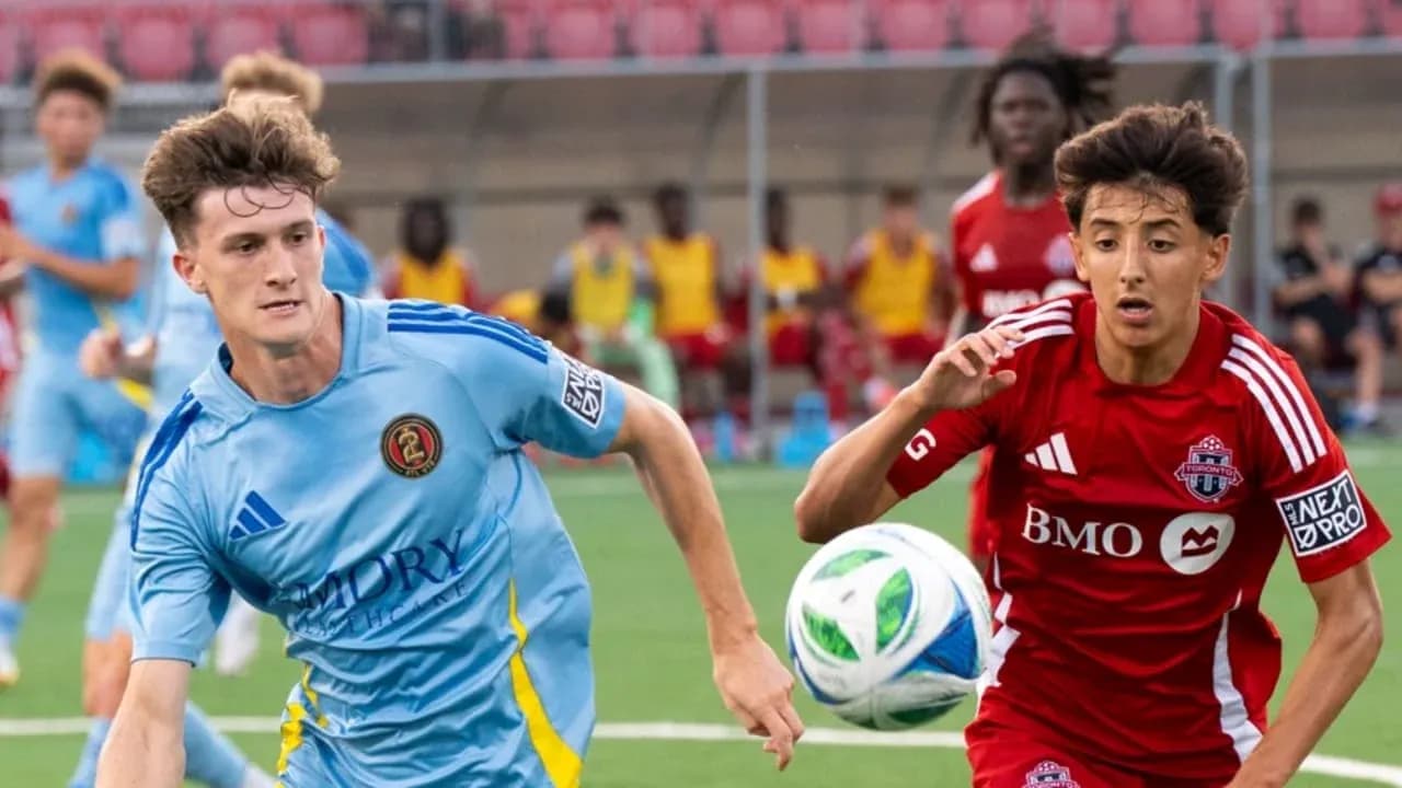 Atlanta United II player challenging Toronto II opponent