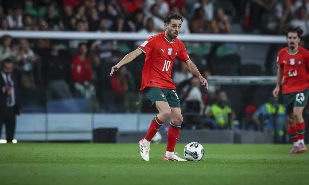 Player in red jersey dribbling ball on field