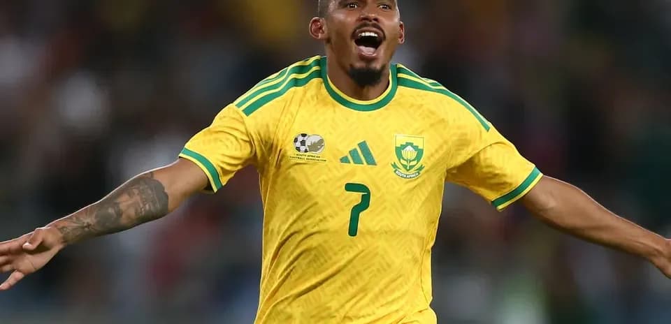 Player celebrating a goal in yellow South Africa jersey