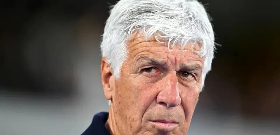 Coach with gray hair looking intently at camera
