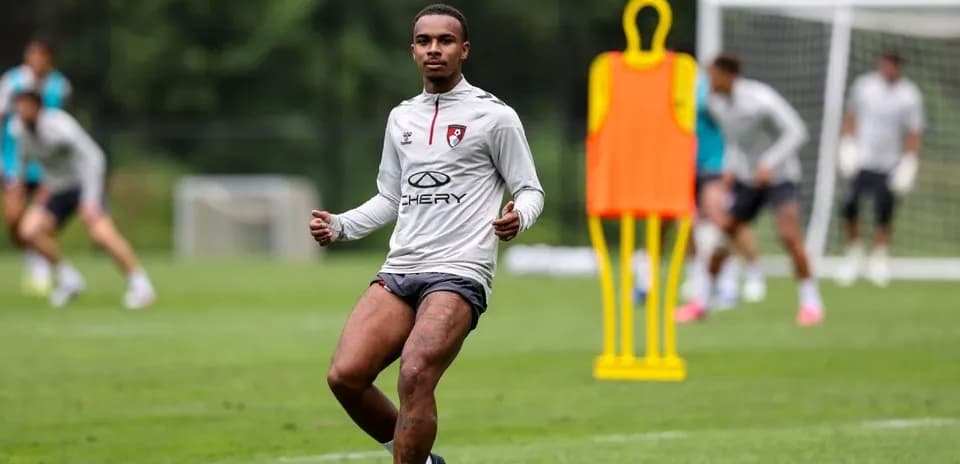 Player training on field with teammates in background