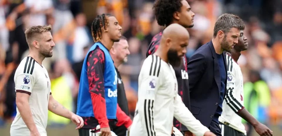 Players and manager walking off the pitch after match