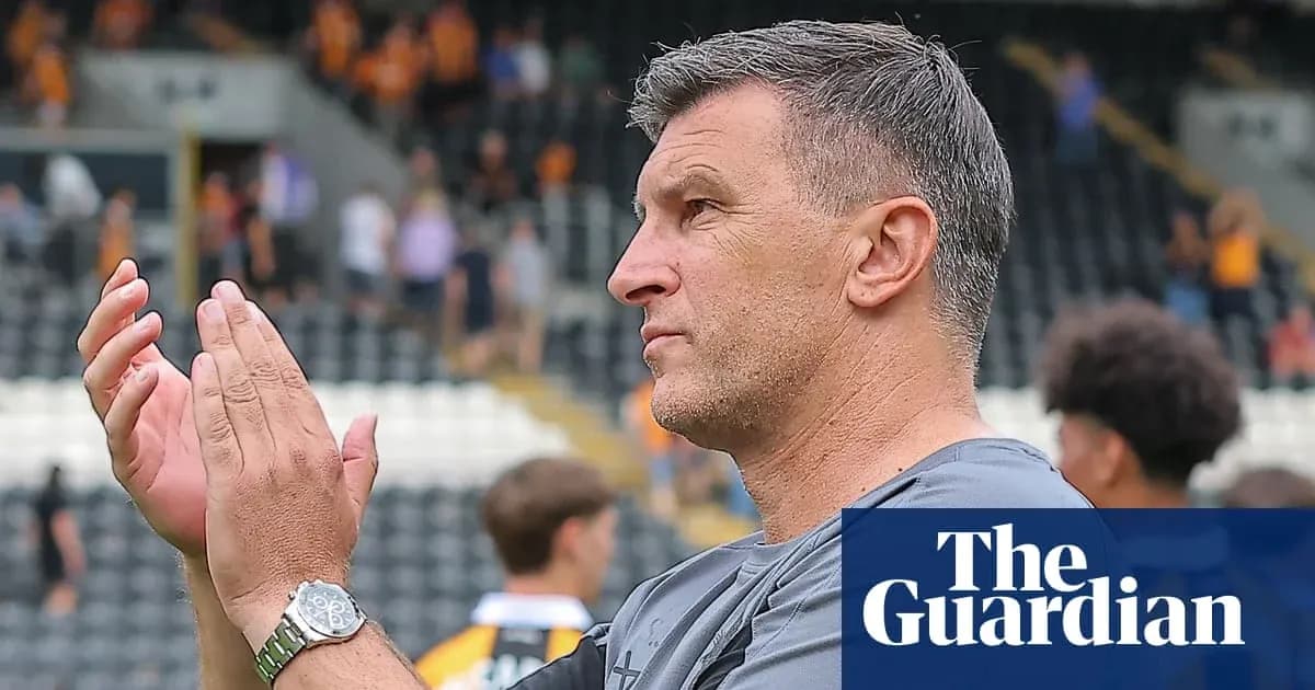 Coach applauding fans in stadium after match