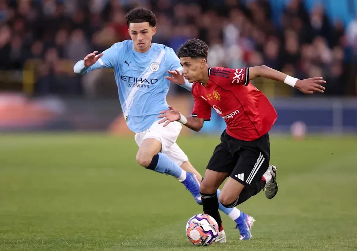 Player from Manchester United dribbling past Manchester City opponent