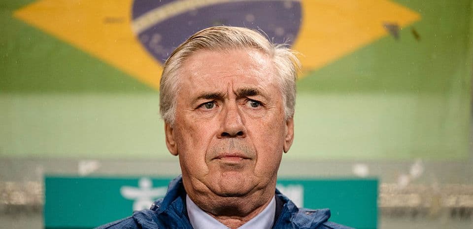 Coach standing in front of Brazil flag backdrop