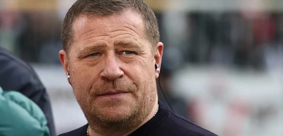 Man wearing headphones, looking serious outdoors