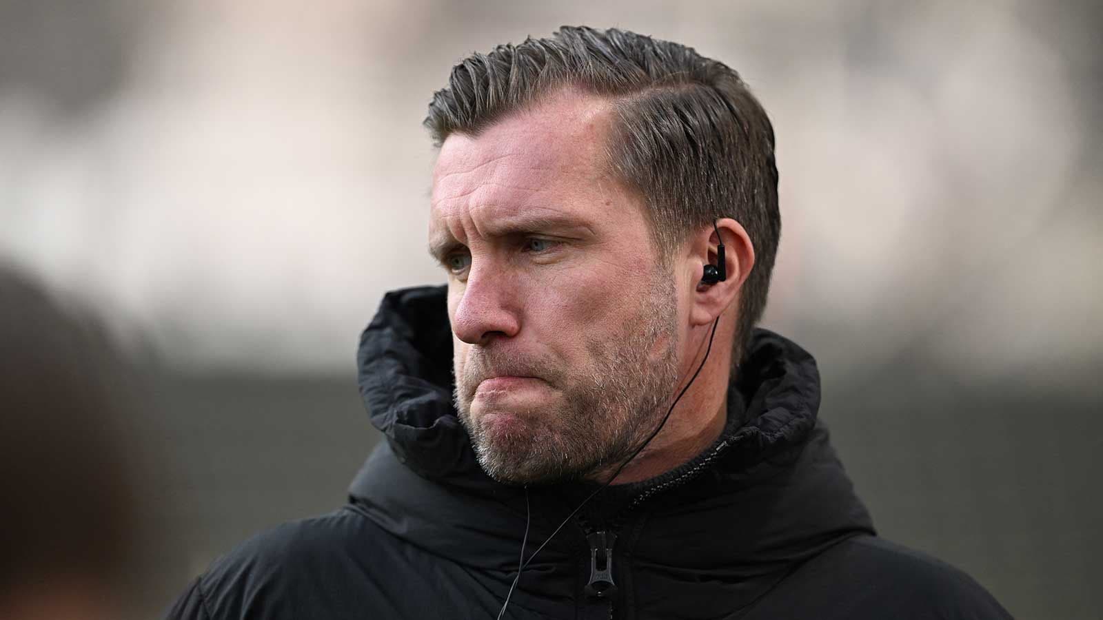 Coach wearing earpiece during training session