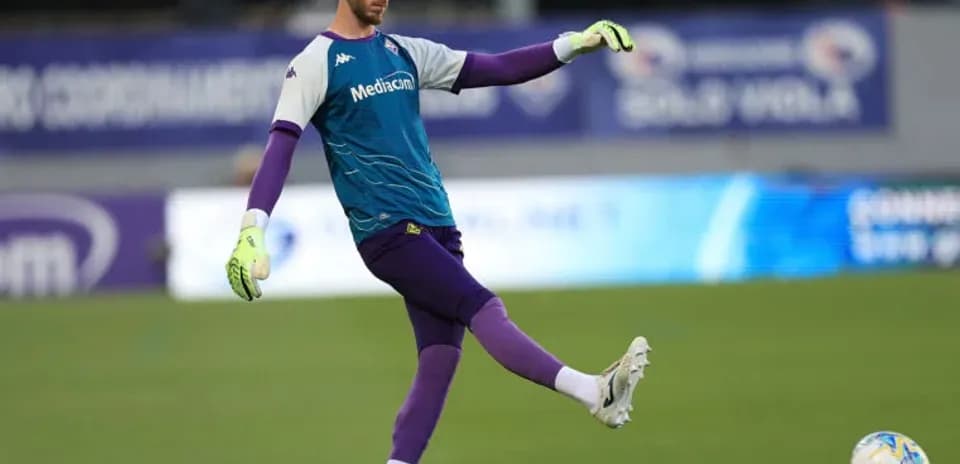 Goalkeeper practicing kicking the ball during warm-up