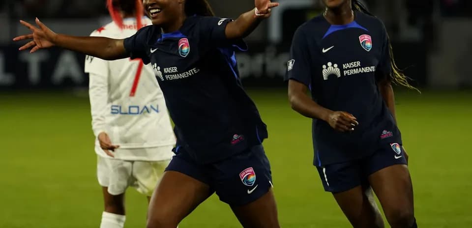 Players celebrating during NWSL match