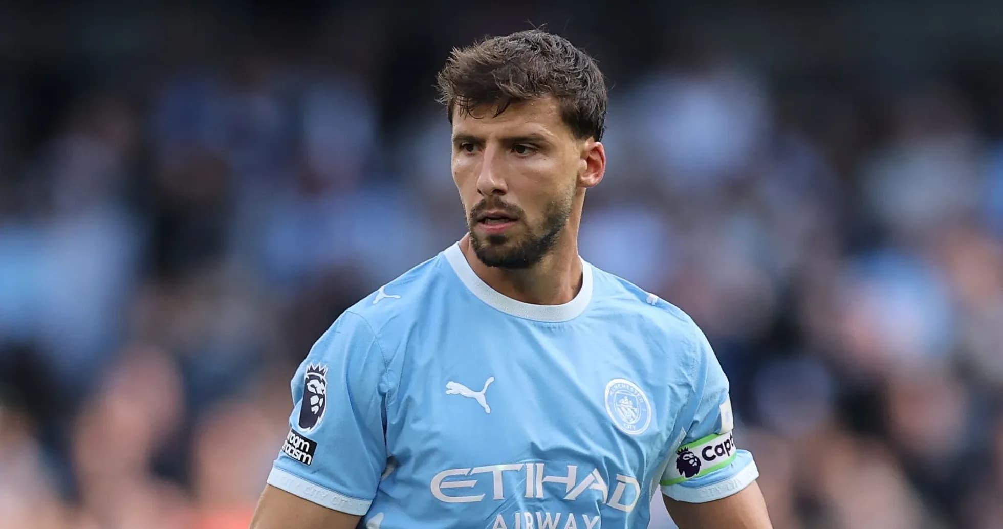 Manchester City player in light blue kit on field