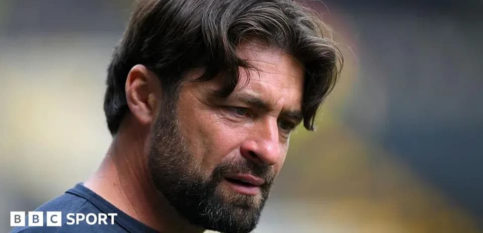 Coach focused during pre-match preparations