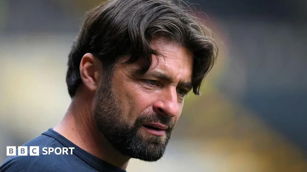 Coach focused during pre-match preparations